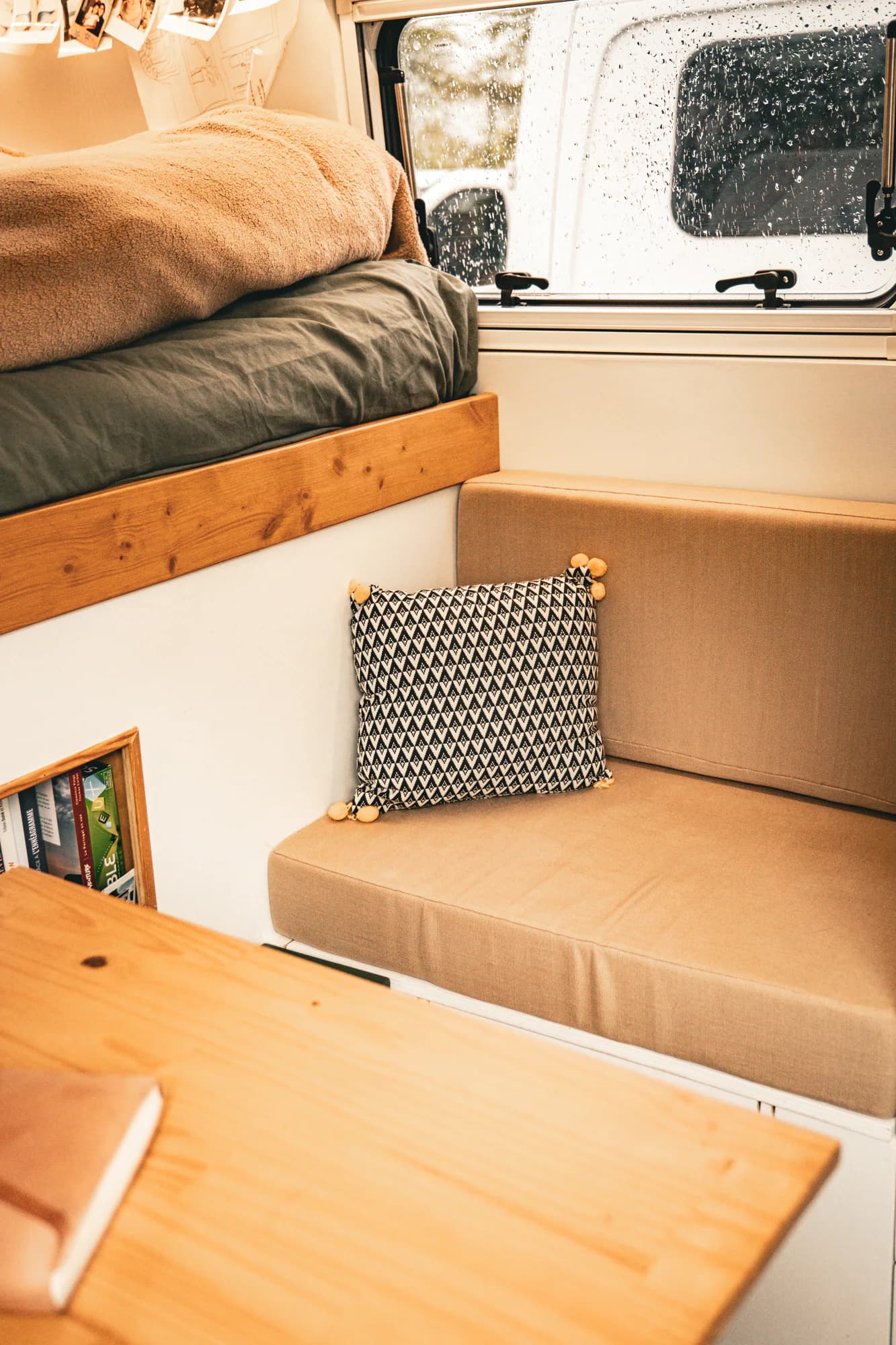 Coin nuit et assise sur mesure dans un fourgon aménagé.